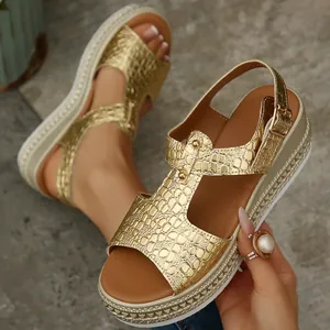 Detailed view of women's gold wedge platform sandals featuring crocodile embossed texture