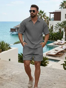 Lifestyle view of men's casual gray waffle knit quarter-zip polo and shorts set