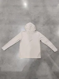 Back view of a beige men's waffle knit hoodie featuring textured fabric and hood