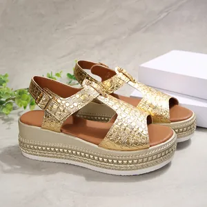 Close-up of metallic gold crocodile pattern platform sandals with buckle strap