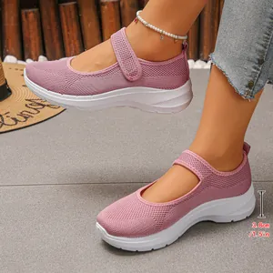 Close-up detail of pink breathable mesh fly-knit walking shoes with a 1.5-inch heel