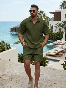 Men's olive green textured waffle knit half-zip polo and shorts set in resort setting