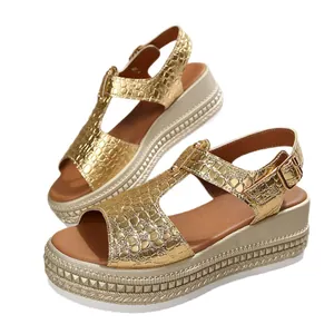 Fashionable women's gold metallic crocodile platform sandals with peep-toe and wedge heel