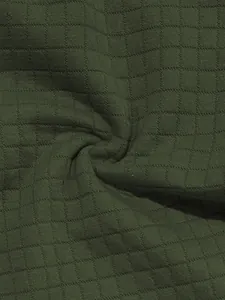 Close-up macro view of olive green waffle knit fabric texture for men's casual polo set