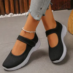 Detail shot of black breathable mesh Mary Jane walking shoes for women with white sole.