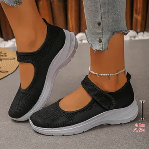 Detailed view of black breathable fly-knit Mary Jane sneakers with a 1.5 inch thick sole