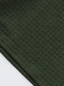 Close-up detail of dark green waffle knit fabric for men's casual polo sports set