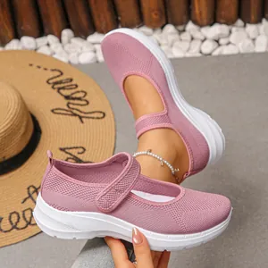 Close-up of pink breathable mesh fly-knit flats with adjustable Mary Jane strap.