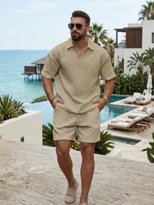 Stylish men's summer waffle knit half-zip polo shirt and shorts set in beige luxury resort