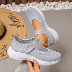Detailed view of grey breathable mesh fly-knit flats with comfortable soft white sole