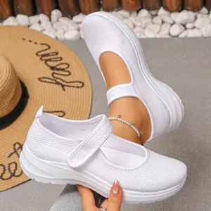 Detailed view of white breathable fly-knit mesh walking shoes with comfortable soft sole