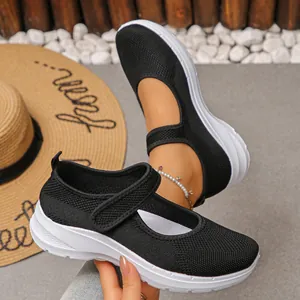 Close-up of black breathable fly-knit Mary Jane shoes with comfortable white sole