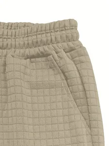 Close-up detail of men's waffle knit casual shorts showing elastic waistband and texture.