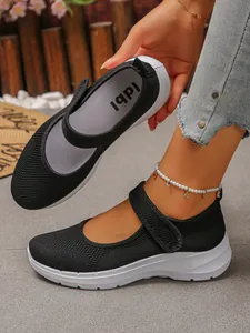 Close-up of black breathable mesh Mary Jane flats with comfortable white soles