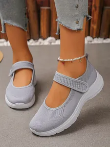 Close-up of grey breathable mesh Mary Jane walking shoes with Velcro strap on-foot.
