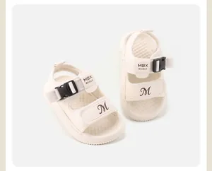 Close-up detail of cream baby walking sandals with adjustable straps and non-slip sole