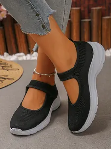 Close-up of breathable black mesh Mary Jane sneakers with a comfortable white soft sole.