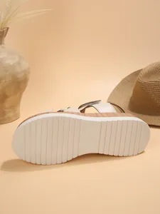 Close-up of non-slip white sole on stylish wedge sandals with size 37 mark