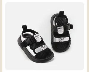 Detailed macro shot of silver and black baby sandals featuring soft non-slip soles for toddlers