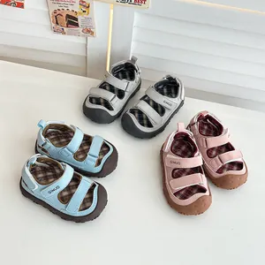 Set di tre sandali estivi per bambini con punta chiusa in blu, rosa e grigio.