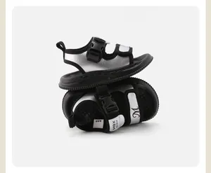 Detailed side view of silver children's sandals with secure black buckle straps.