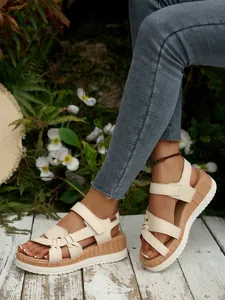 Beige platform wedge sandals for women featuring wood-grain soles and adjustable straps