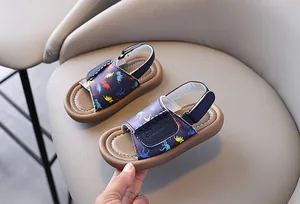 Detail of children's dinosaur print sandals with soft sole and adjustable straps