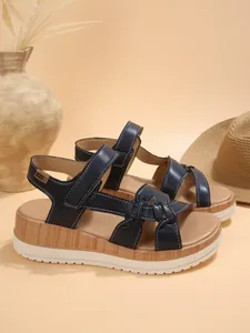 Navy blue platform sandals featuring wood grain wedge heel and knot strap detail for summer