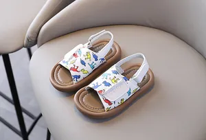 Detailed view of children's sandals featuring colorful dinosaur prints and velcro