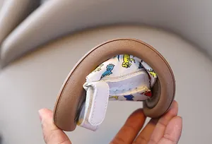 Close-up detail showing the flexible soft sole of a dinosaur print toddler sandal