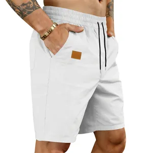 Close-up of white quick-dry beach shorts for men with elastic waist and drawstring