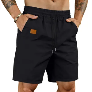 Detail view of men's black quick-dry shorts featuring elastic drawstring waist