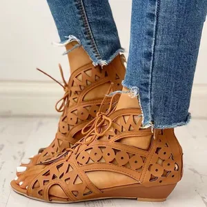 Nahaufnahme der braunen Damen-Sandalen im Ethno-Stil mit modischen Lochmustern und Schnürung