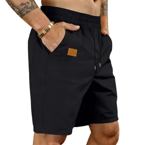 Close-up detail of men's black quick-dry casual shorts with elastic drawstring waist