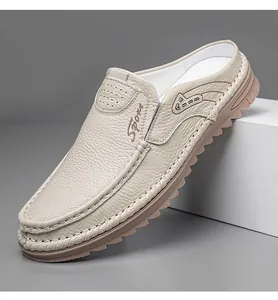 Detailed view of beige leather men's mules with hand-stitched seams and textured finish