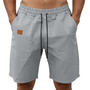 Detail view of lightweight quick-dry men's casual beach shorts in light gray color