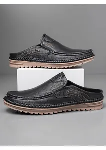 Detail shot of black leather mule loafers with slip-on design and durable rubber sole