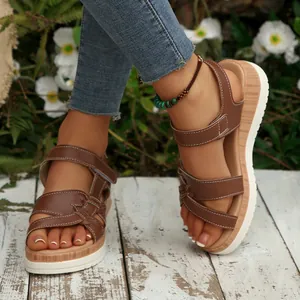 Stylish brown women's platform wedge sandals with cross straps for casual summer wear