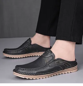 Side view of men's black genuine leather mules featuring slip-on design and soft soles