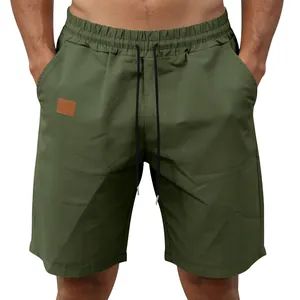 Casual olive green quick-dry men's beach shorts with elastic waist and drawstring