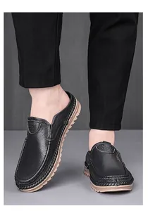 Detail view of men's black genuine leather mules with non-slip soft rubber soles
