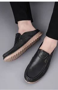 Detailed shot of men's black leather slip-on mules with soft non-slip soles.