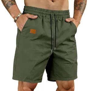 Army green quick-dry men's athletic shorts with drawstring waist and patch detail