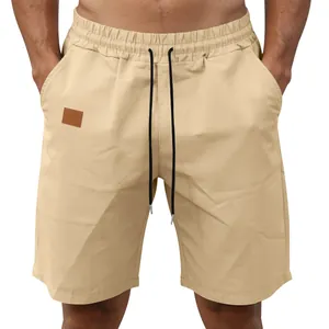Front view of men's khaki quick-dry casual shorts with drawstring and brown patch