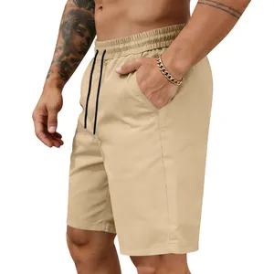 Detail of men's quick-dry khaki shorts featuring elastic waistband and black drawstring
