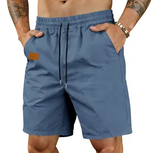 Macro view of blue men's quick-dry shorts showing the elastic drawstring waistband.