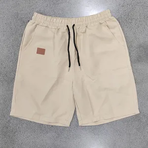 Detailed flat lay view of men's khaki quick-dry casual shorts with black drawstrings