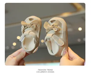 Soft beige baby princess sandals with elegant bow detail and protective closed-toe design.