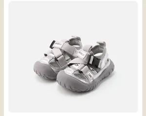 Close-up of silver breathable baby sandals with soft soles and adjustable straps