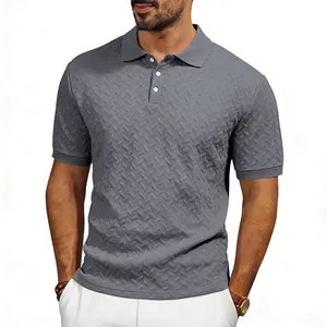 Close-up of men's grey textured polo shirt showing chevron jacquard pattern on model